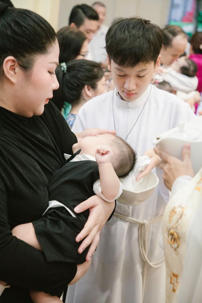 pexels-photo-27023212 A woman holding a baby in a church